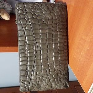 Liebskind clutch coverts to a Crossbody with enclosed strap.